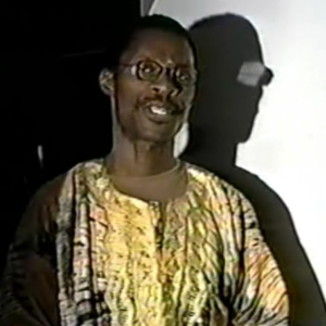 A man in glasses and an african print shirt.